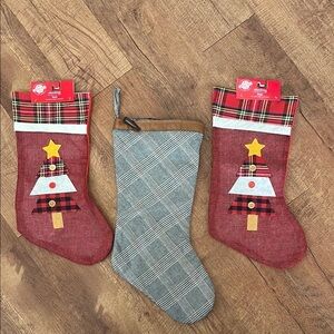 NWT 3 Christmas stockings. 2 red Christmas trees, 1 plaid w/ faux leather top.